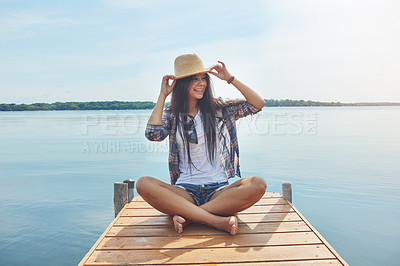 Buy stock photo Shot of an attractive young woman enjoying a day on the beach