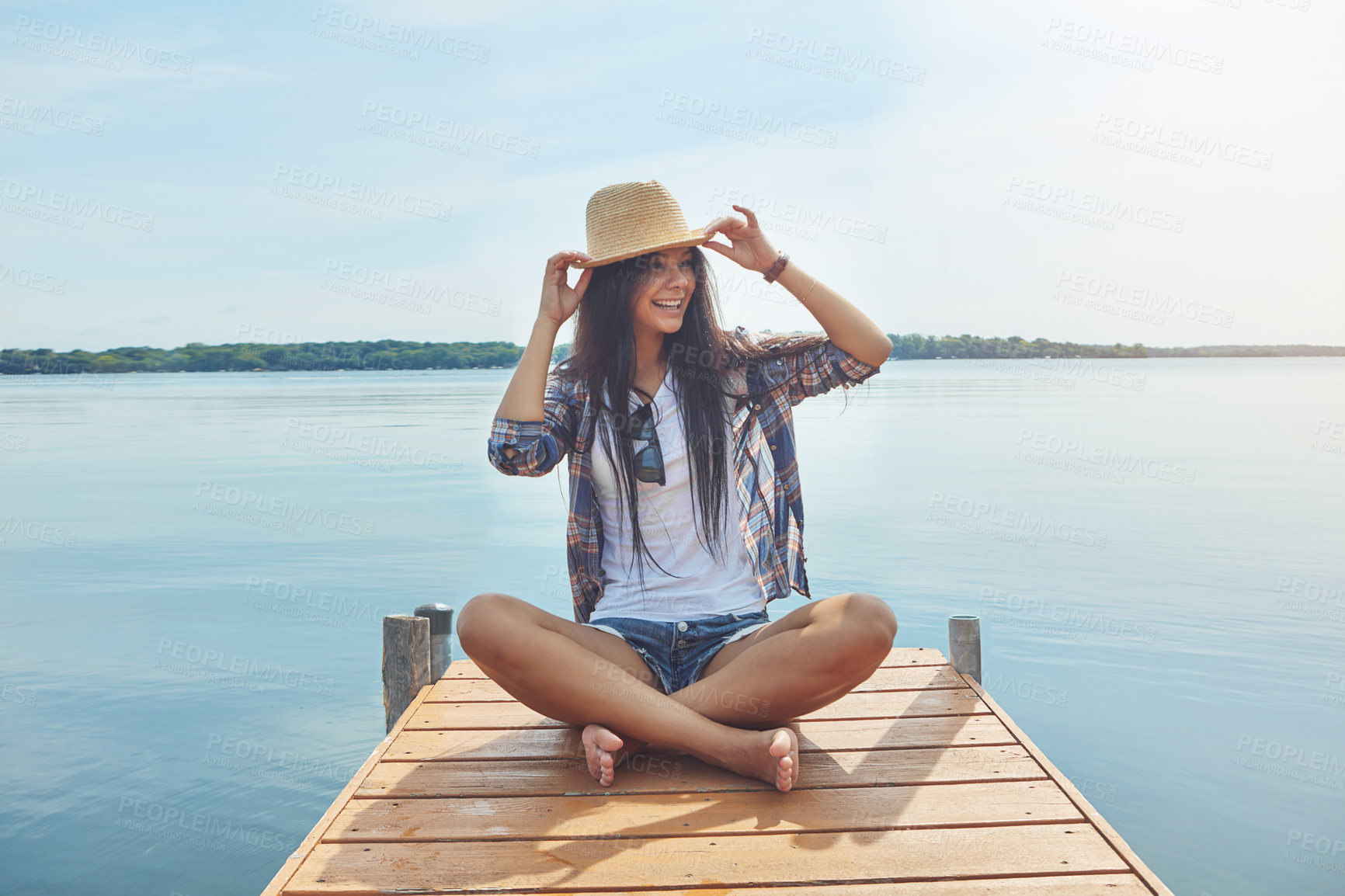 Buy stock photo Shot of an attractive young woman enjoying a day on the beach