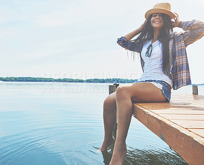 Buy stock photo Shot of an attractive young woman enjoying a day on the beach