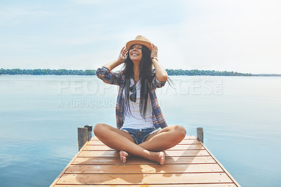 Buy stock photo Shot of an attractive young woman enjoying a day on the beach