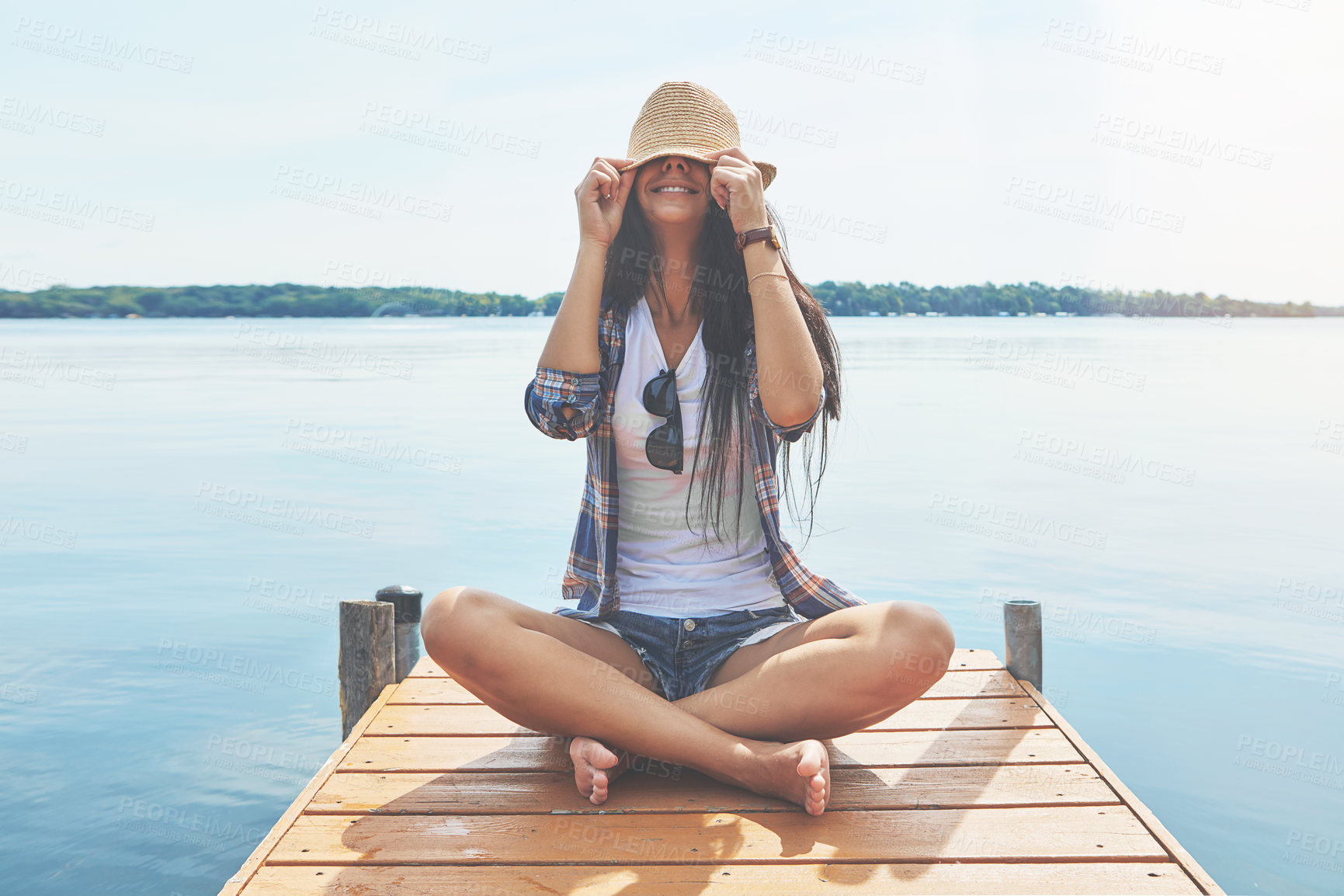 Buy stock photo Shot of an attractive young woman enjoying a day on the beach