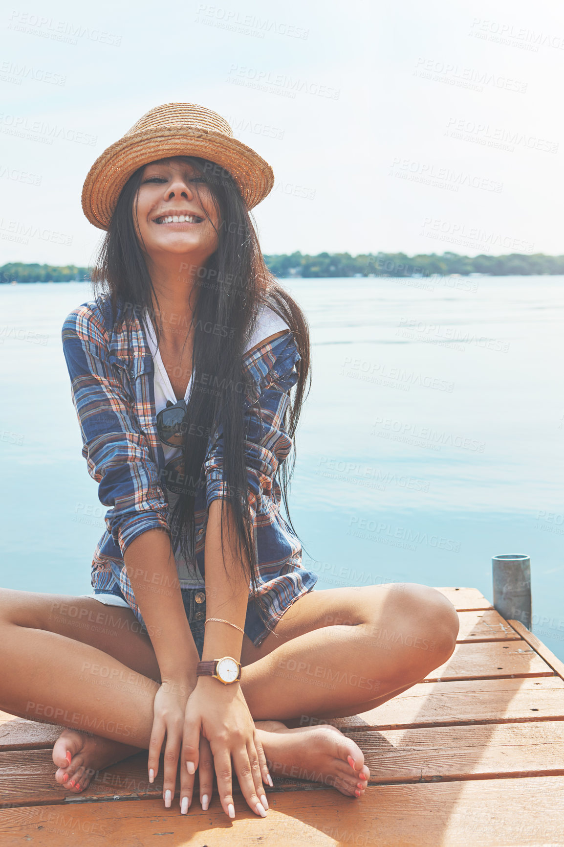 Buy stock photo Shot of an attractive young woman enjoying a day on the beach