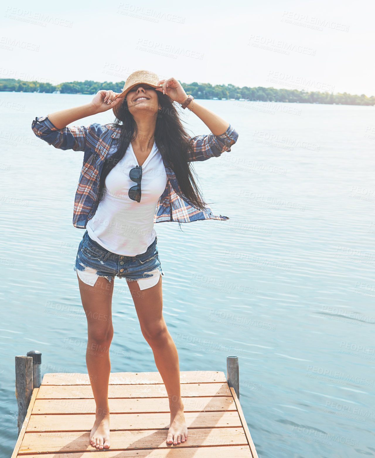 Buy stock photo Shot of an attractive young woman enjoying a day on the beach