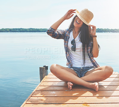 Buy stock photo Shot of an attractive young woman enjoying a day on the beach