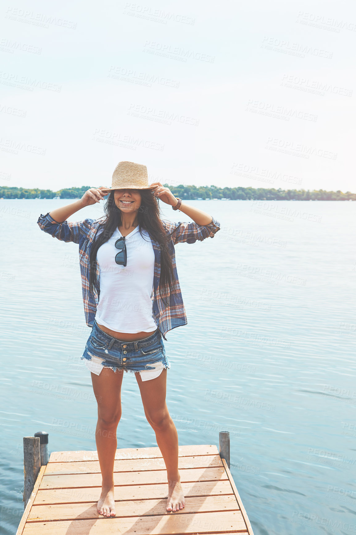 Buy stock photo Shot of an attractive young woman enjoying a day on the beach