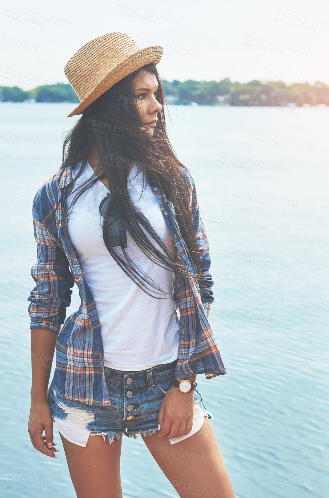 Buy stock photo Shot of an attractive young woman enjoying a day on the beach