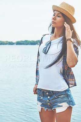 Buy stock photo Shot of an attractive young woman enjoying a day on the beach