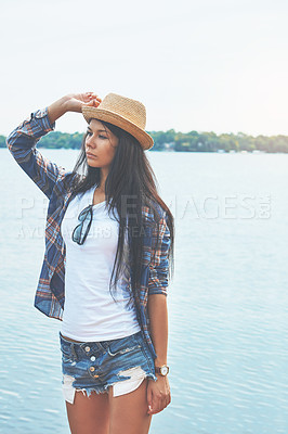 Buy stock photo Shot of an attractive young woman enjoying a day on the beach