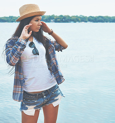 Buy stock photo Shot of an attractive young woman enjoying a day on the beach