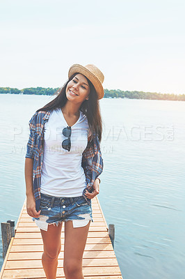 Buy stock photo Shot of an attractive young woman enjoying a day on the beach