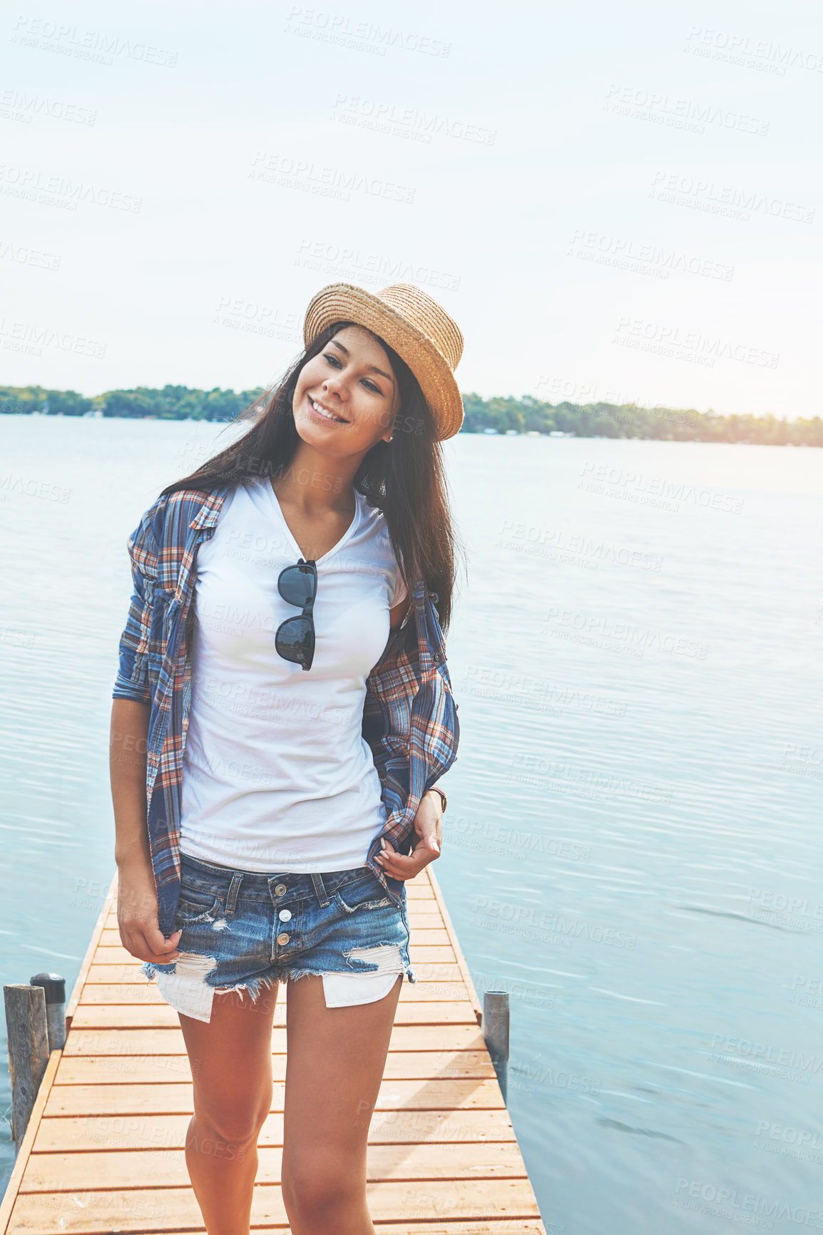 Buy stock photo Shot of an attractive young woman enjoying a day on the beach