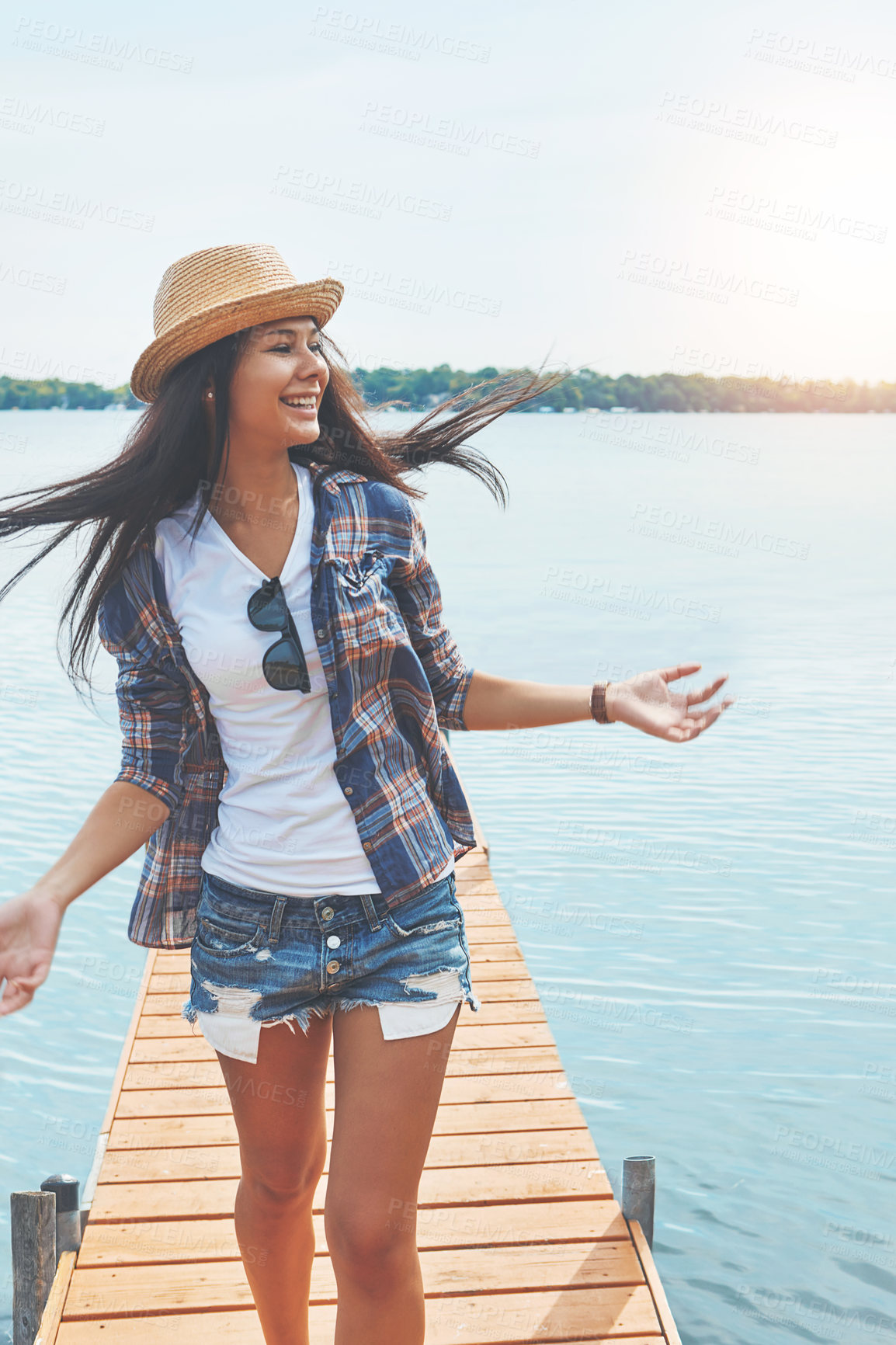 Buy stock photo Shot of an attractive young woman enjoying a day on the beach