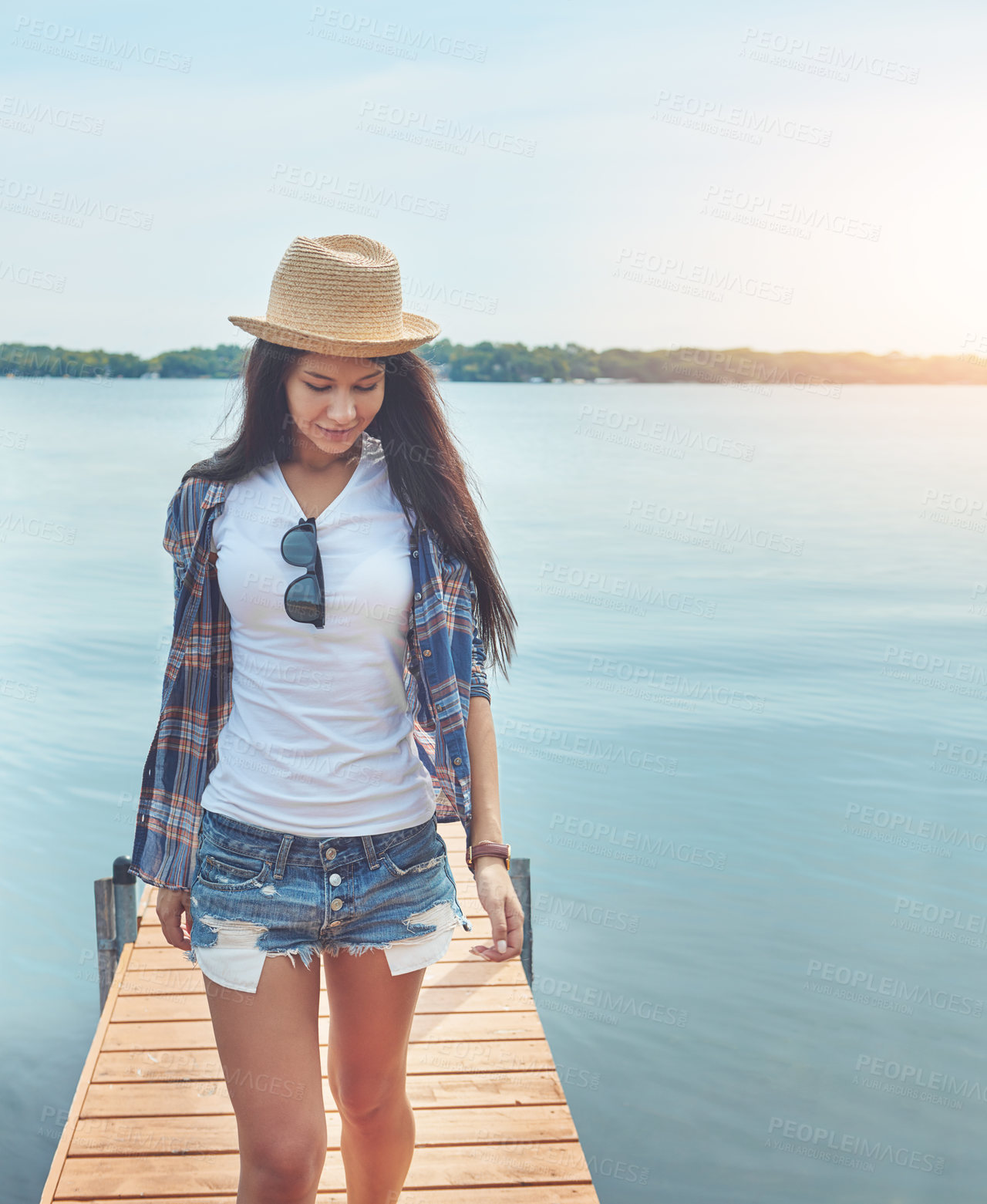 Buy stock photo Shot of an attractive young woman enjoying a day on the beach