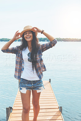 Buy stock photo Shot of an attractive young woman enjoying a day on the beach