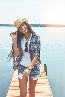 Buy stock photo Shot of an attractive young woman enjoying a day on the beach