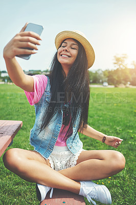 Buy stock photo Smile, girl and selfie on bench in park for profile picture on social media or memory of summer vacation in California. Woman, sunshine and holiday with photography or live blog for content creation.