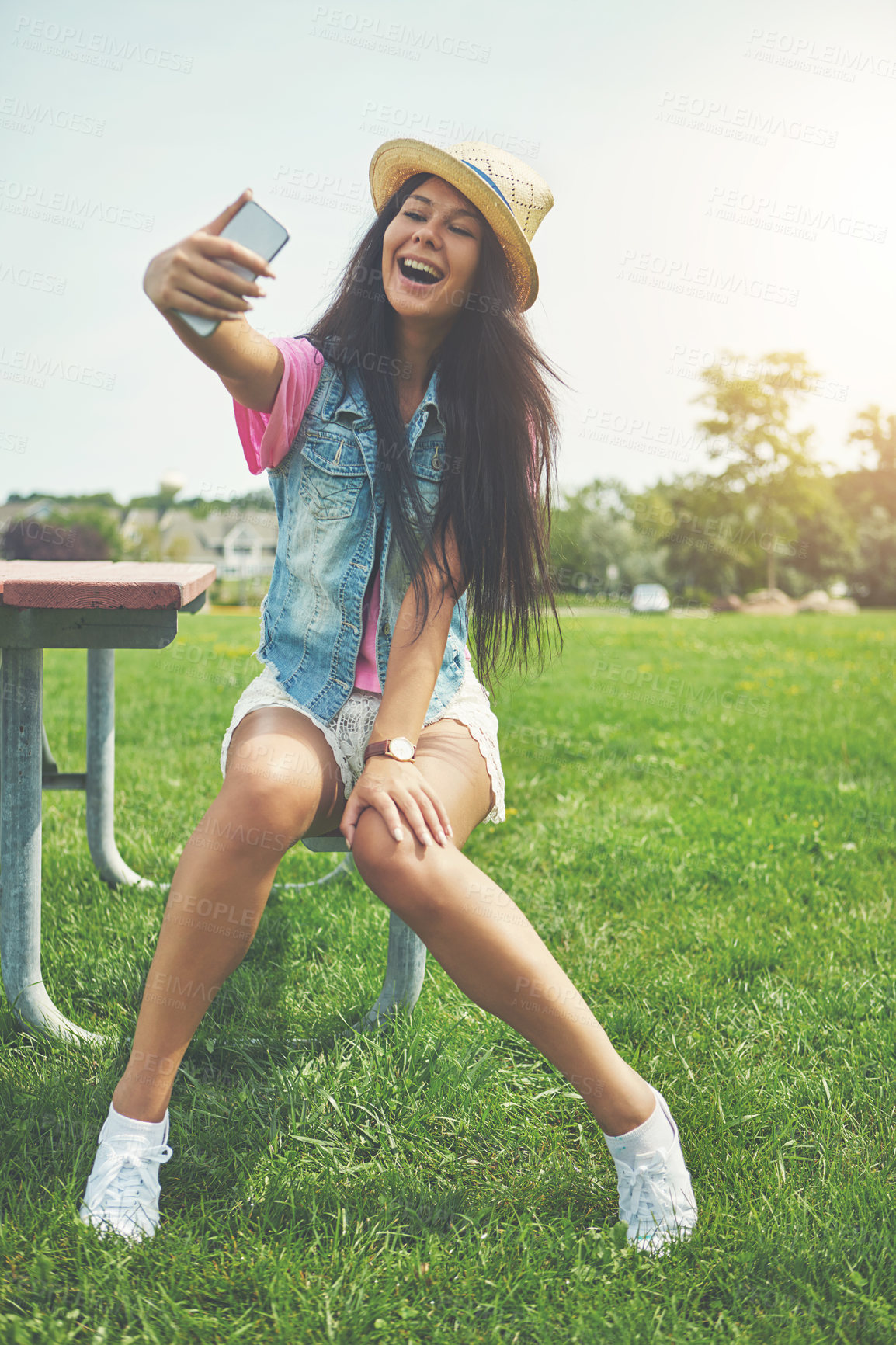 Buy stock photo Smile, girl and selfie on bench in park for profile picture on social media or memory of summer vacation in California. Woman, sunshine and holiday with photography or live blog for content creation.