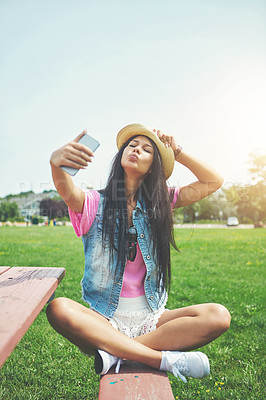 Buy stock photo Outdoor, girl and selfie with attitude in park for profile picture on social media or memory of summer vacation in California. Woman, pout and hat with photography or live blog for content creation.