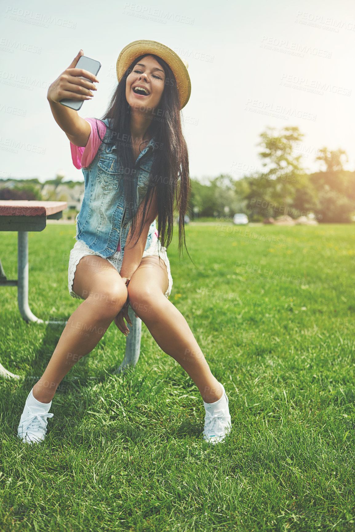 Buy stock photo Happy, girl and selfie on bench in park for profile picture on social media or memory of summer vacation in California. Woman, sunshine and holiday with photography or live blog for content creation.