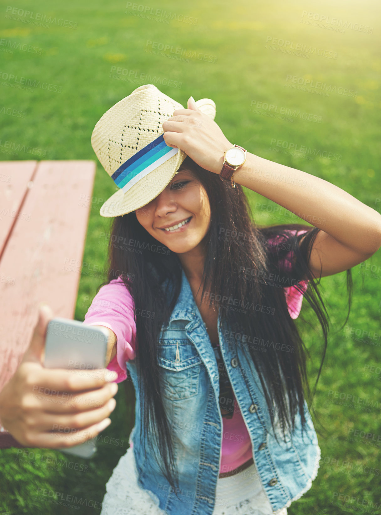 Buy stock photo Outdoor, girl and selfie on bench in park for profile picture on social media or memory of summer vacation in California. Woman, holiday and sunshine with photography for post with hat and attitude.