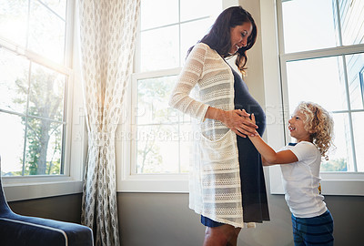 Buy stock photo Cropped shot of a pregnant woman bonding with her little son at home