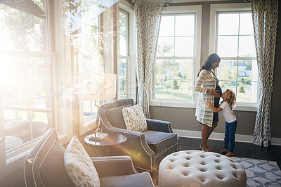 Buy stock photo Shot of a little boy kissing his mother's pregnant stomach at home