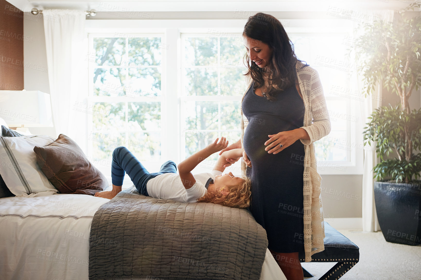 Buy stock photo Happy family bedroom, pregnant woman and kid touch stomach, abdomen or belly for baby care, development or maternity. Mother, young girl and child check life growth, pregnancy or movement on home bed