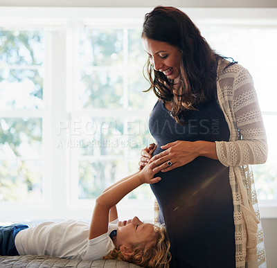 Buy stock photo Home bedroom, pregnant woman and child touch, feel or massage stomach to check prenatal fetus movement. Expectation, mother and daughter curious for life growth, pregnancy or baby development on bed