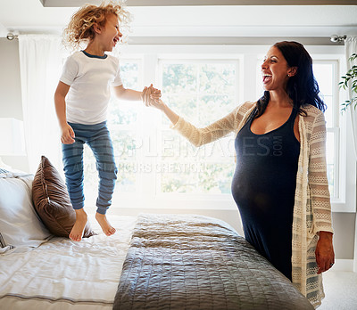 Buy stock photo Happy family bedroom, pregnant woman and child jump, excited and have fun to celebrate baby maternity development. Happiness, energy or kid smile for life growth, pregnancy or expectation on home bed