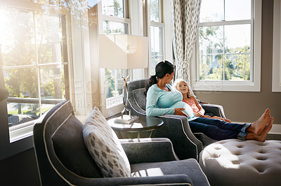 Buy stock photo Shot of a pregnant woman spending time with her daughter at home