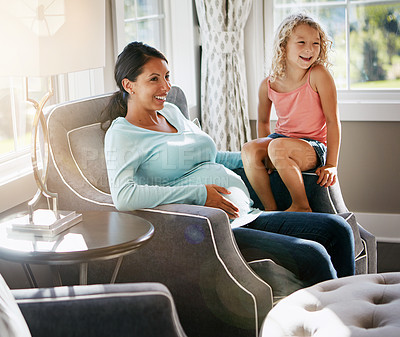 Buy stock photo Shot of a pregnant woman spending time with her daughter at home