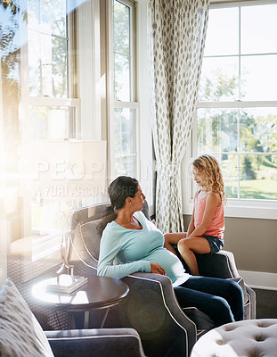 Buy stock photo Shot of a pregnant woman spending time with her daughter at home