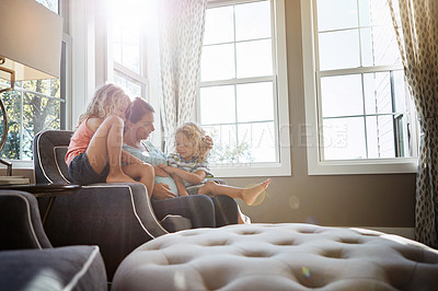 Buy stock photo Shot of a pregnant woman spending time with her children at home