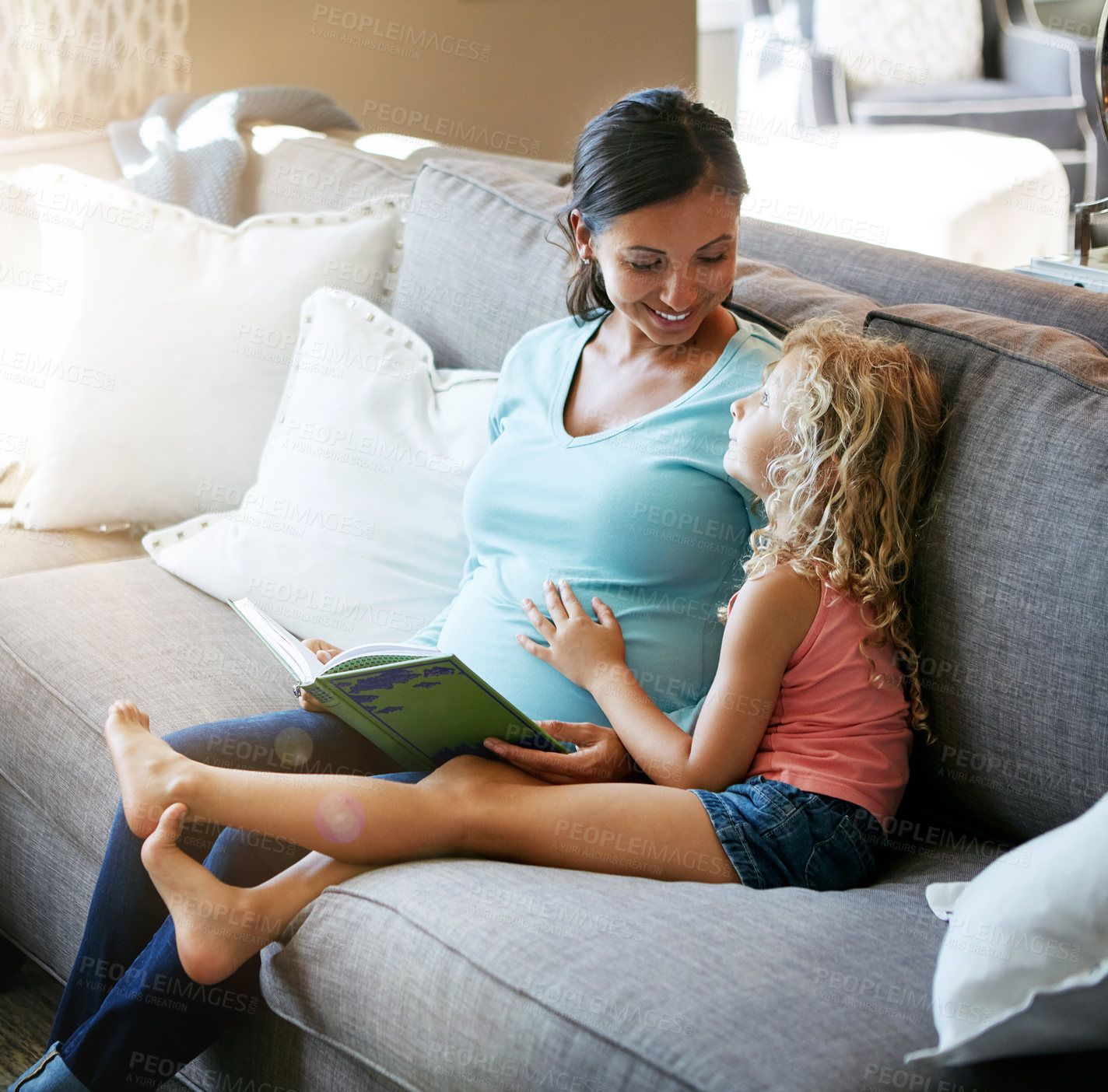 Buy stock photo Shot of a pregnant woman spending time with her daughter at home