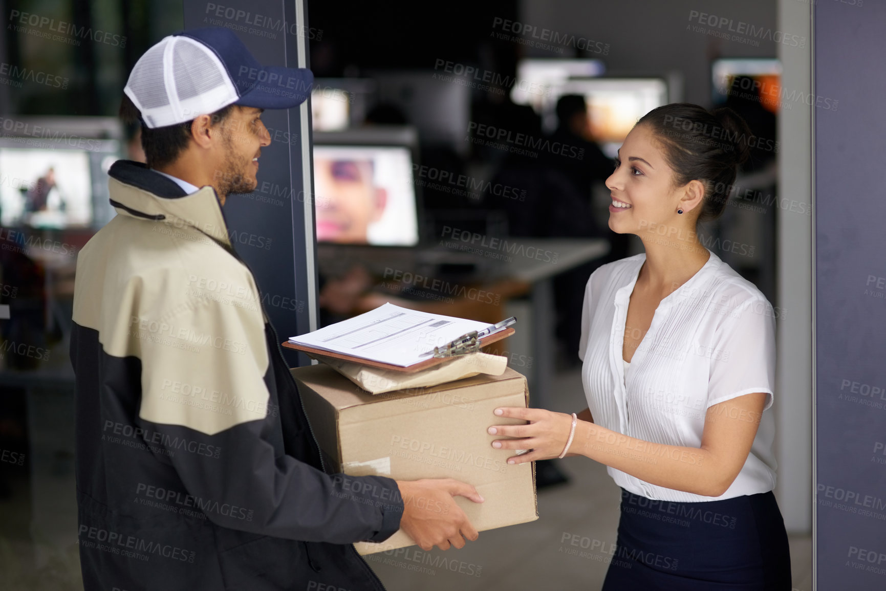 Buy stock photo Cropped shot of a courier making a delivery to a businesswoman at her office