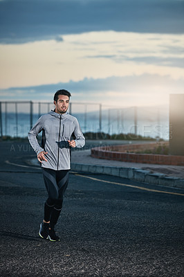 Buy stock photo Shot of a sporty young man out for a run