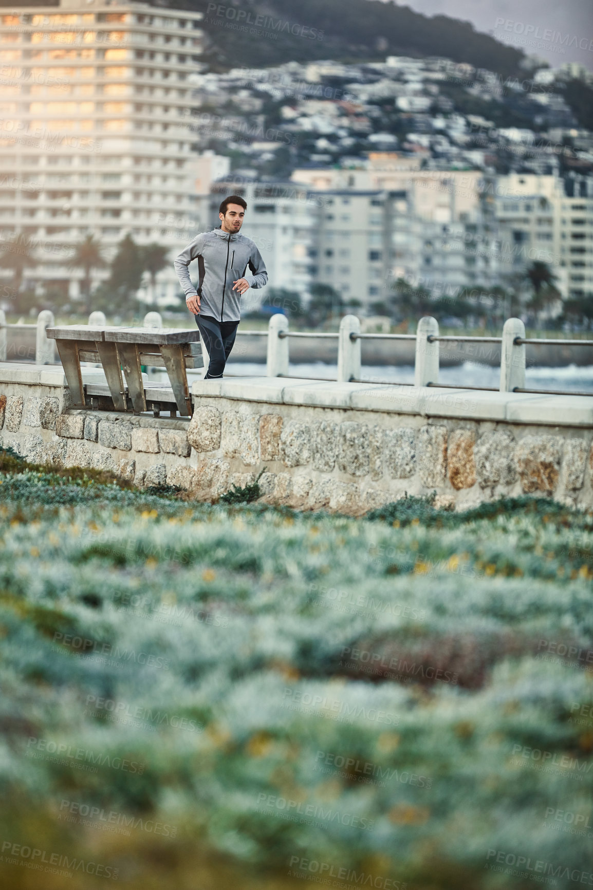 Buy stock photo Shot of a sporty young man out for a run