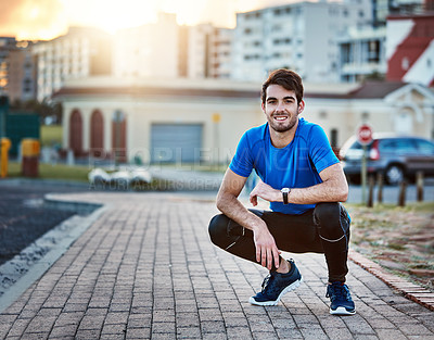 Buy stock photo Shot of a handsome young man exercising outdoors
