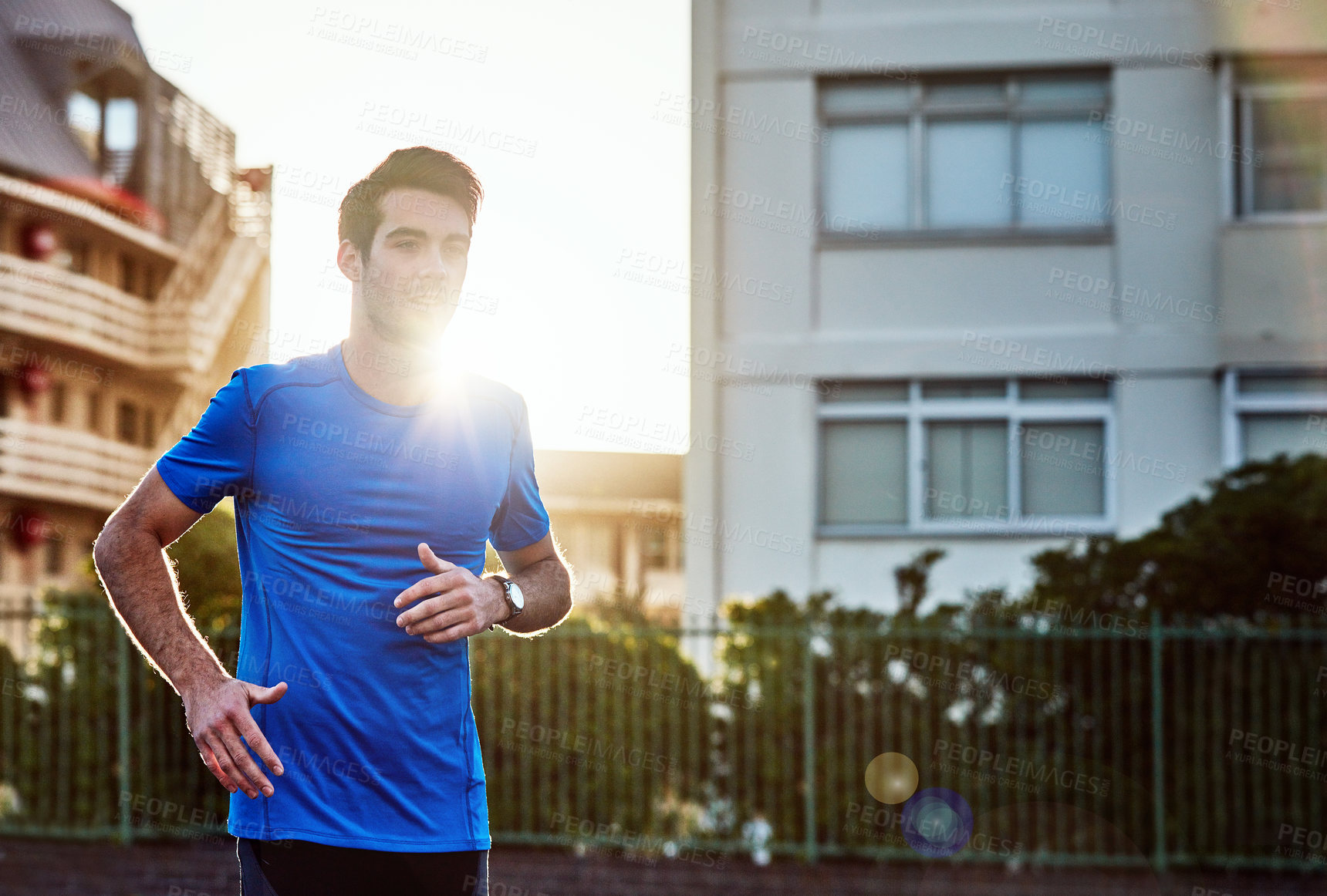 Buy stock photo Shot of a sporty young man out for a run