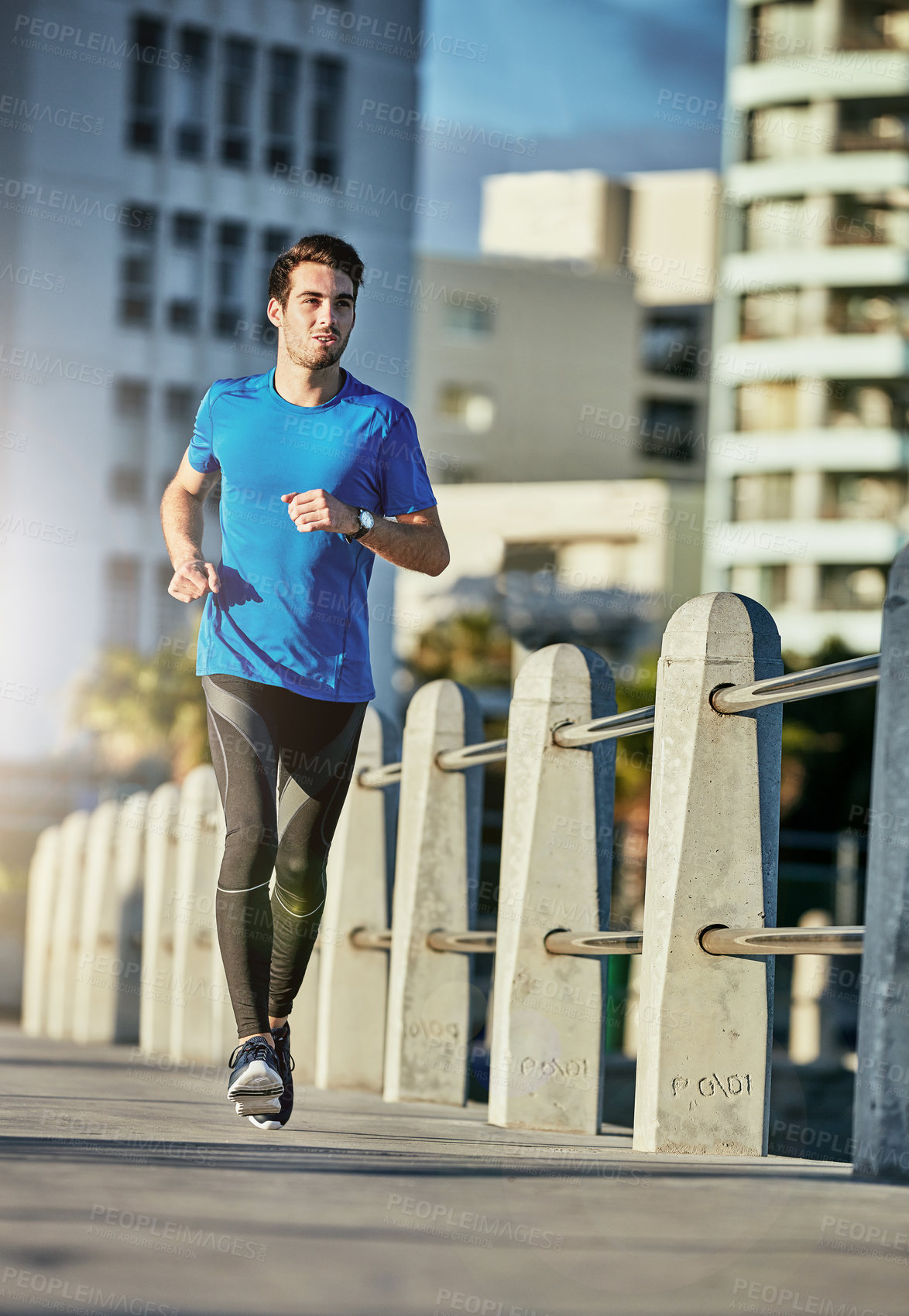 Buy stock photo Shot of a sporty young man out for a run