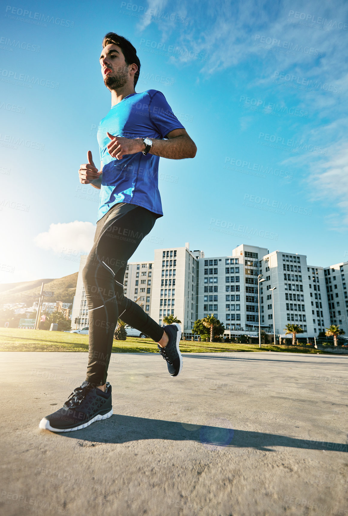 Buy stock photo Shot of a sporty young man out for a run