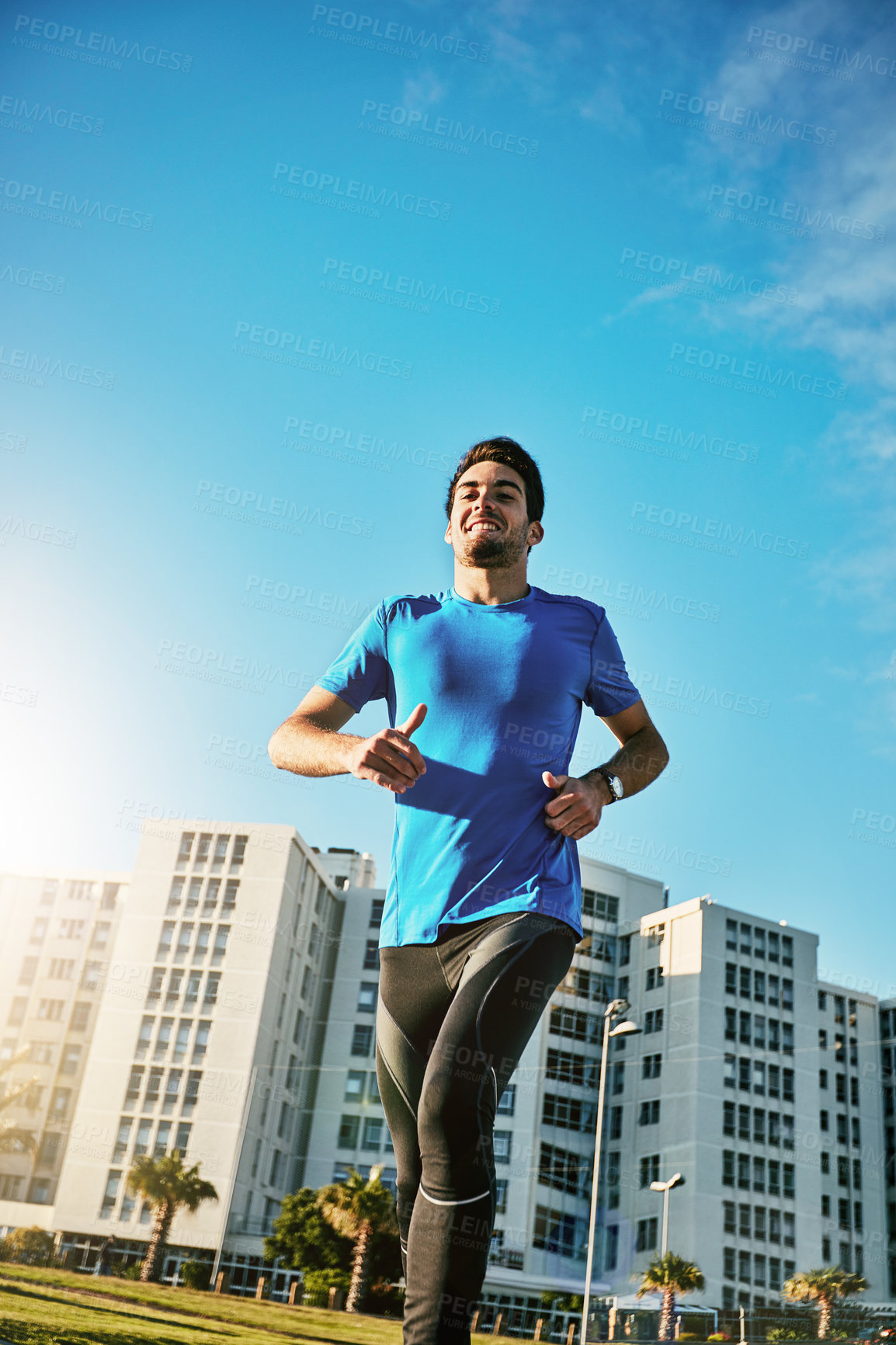 Buy stock photo Running, fitness and low angle with man outdoor for workout, cardio challenge and sports athlete. Training, exercise and runner wellness with male person in city for performance, endurance and health