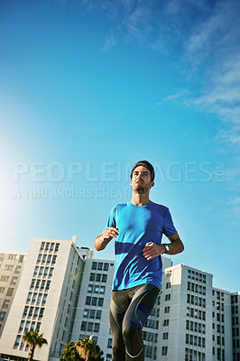 Buy stock photo Shot of a sporty young man out for a run