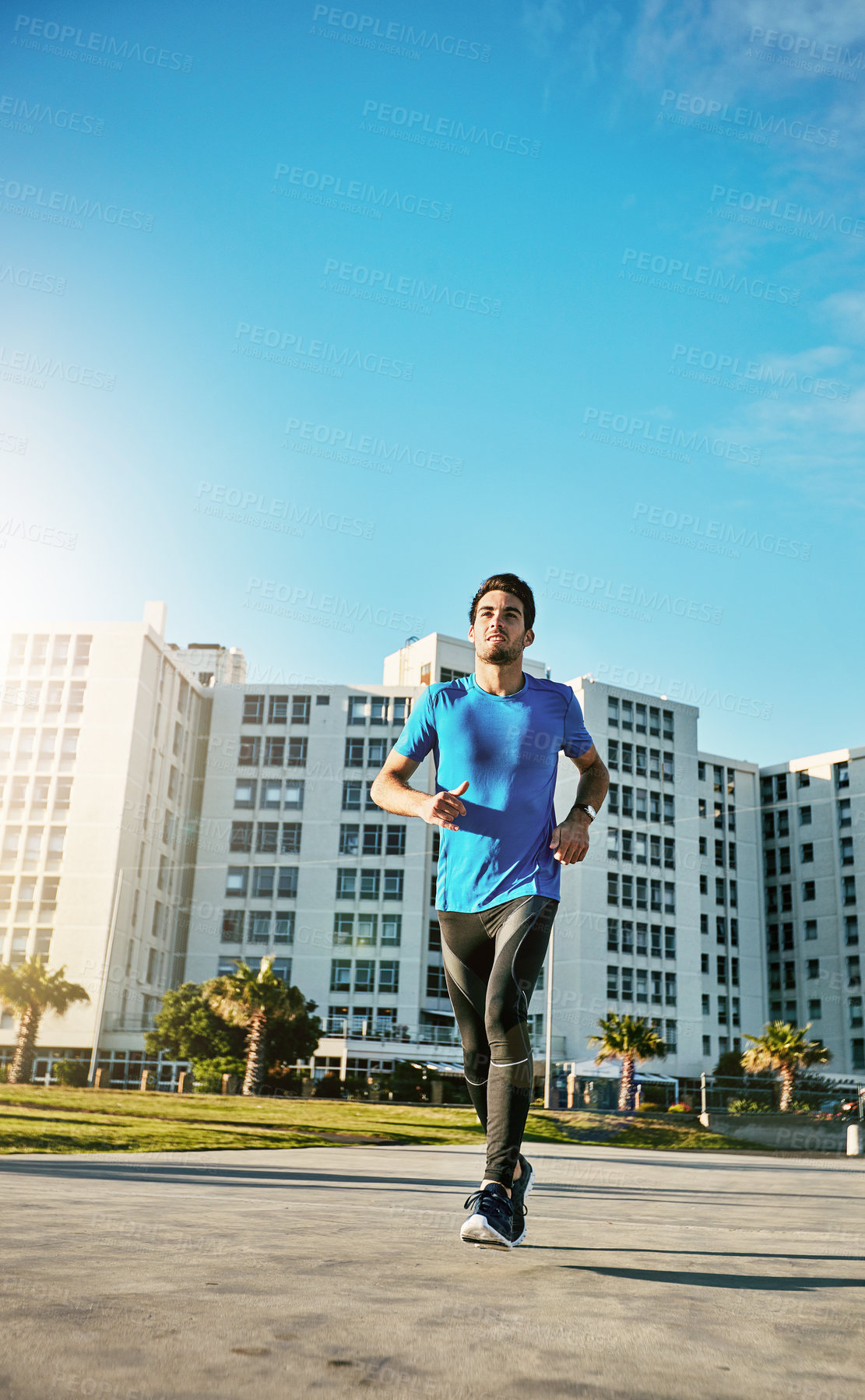 Buy stock photo Shot of a sporty young man out for a run