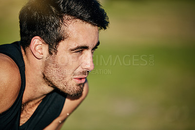 Buy stock photo Cropped shot of a young man out for a run in the park