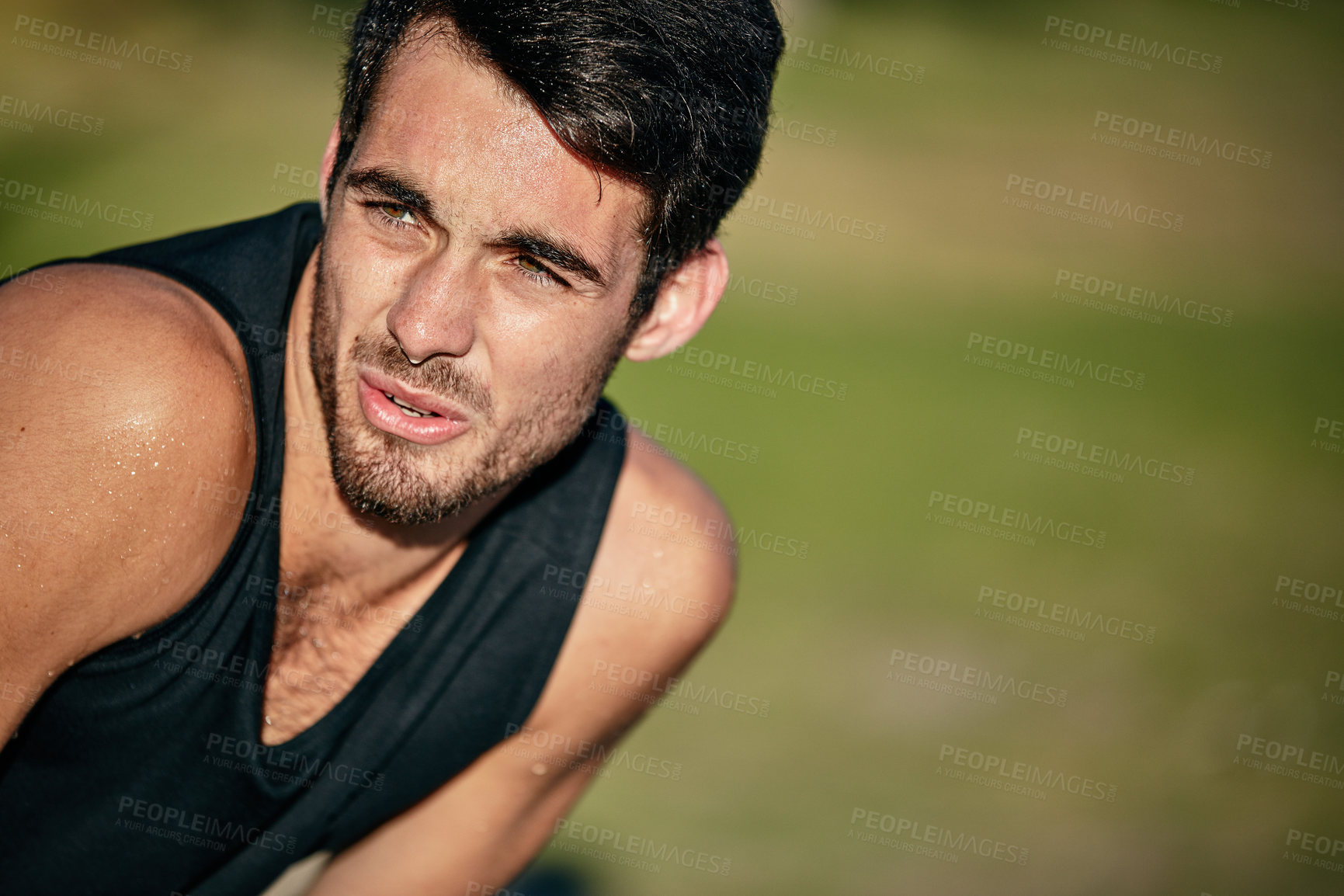 Buy stock photo Cropped shot of a young man out for a run in the park