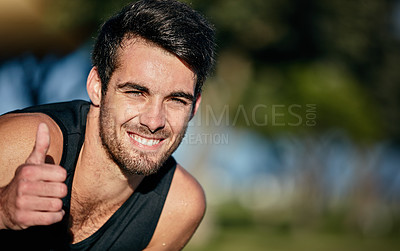 Buy stock photo Portrait of a happy jogger showing a thumbs up while out for a run in a park