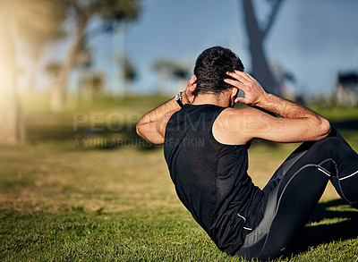 Buy stock photo Shot of a young man in gymwear working out in a park