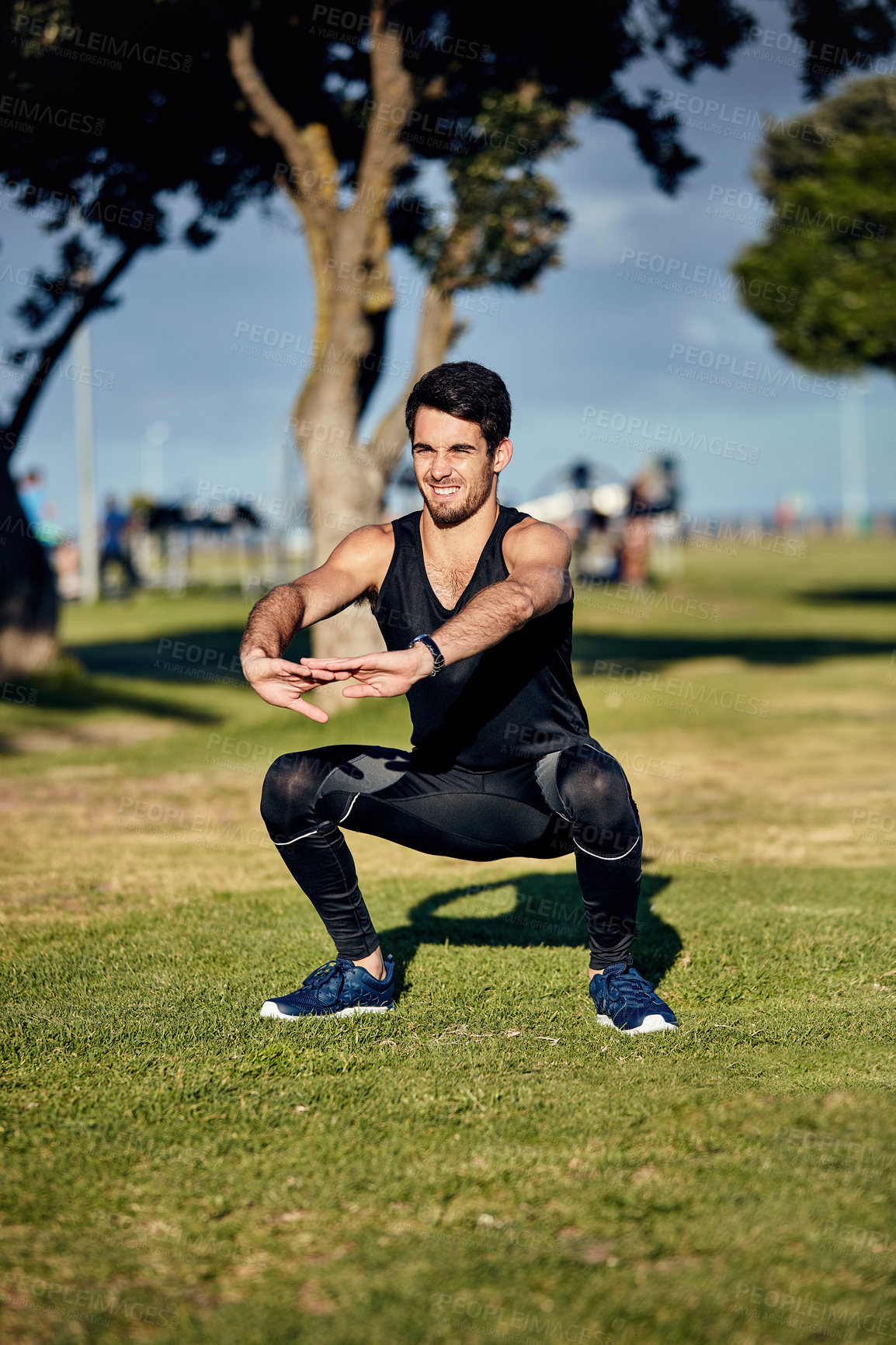 Buy stock photo Shot of a young man in gymwear working out in a park