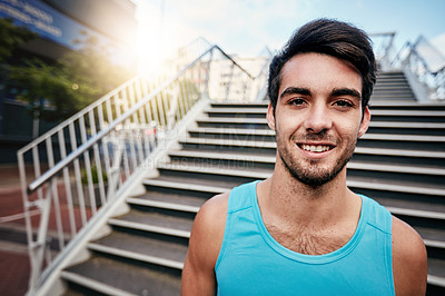 Buy stock photo Cropped portrait of a handsome young man working out in the city